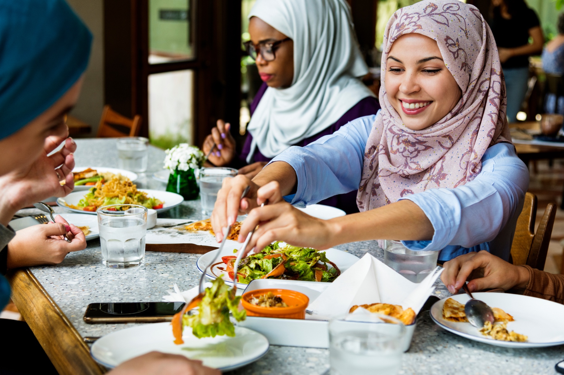 Muslim friends sharing a meal together